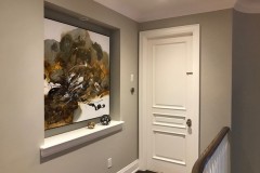 Interior painting in halway with white trim and doors
